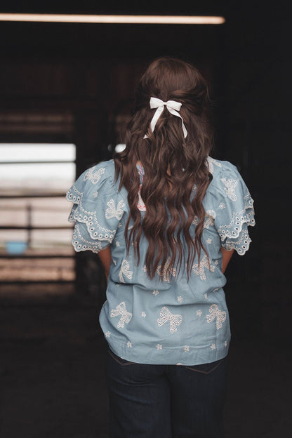 Umgee "All Tied Up" Bow Embroidered Denim Chambray Western Top — Scalloped Ruffle Sleeves Summer Charm (Medium remaining)